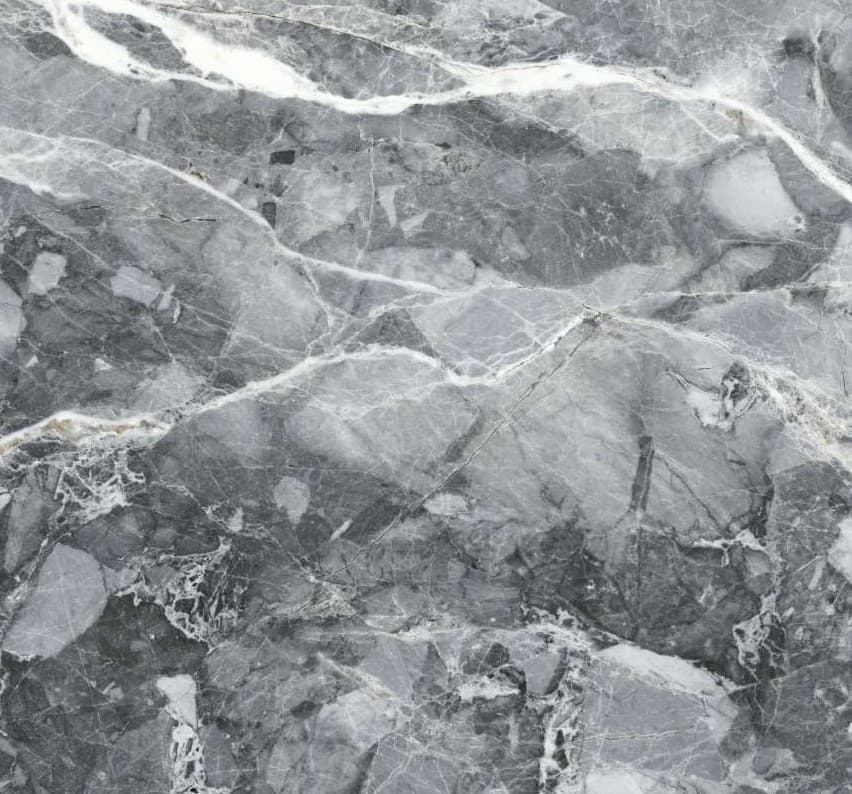 Dark grey ceramic surface with a fragmented fossil-like pattern.